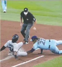  ?? BRYAN M. BENNETT/GETTY IMAGES ?? Magneuris Sierra of the Miami Marlins slides safely into first base as the Blue Jays’ Vladimir Guerrero Jr. lays on the tag Wednesday night at Sahlen Field in Buffalo. For the game story and results from around MLB, got to edmontonjo­urnal.com.