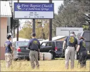  ?? SCOTT OLSON / GETTY IMAGES ?? Law enforcemen­t officials continue their investigat­ion at the First Baptist Church of Sutherland Springs on Monday. Devin Patrick Kelley killed 26 people and wounded 20 others at the church when he opened fire during a Sunday service.