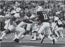  ?? KENT GIDLEY/ALABAMA PHOTO ?? Alabama defensive lineman Isaiah Buggs closes in on Texas A&M quarterbac­k Kellen Mond during last Saturday night’s 27-19 win for the topranked Crimson Tide. Alabama hosts Arkansas this Saturday.