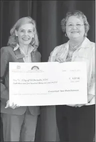  ?? Contribute­d Photos ?? Certified Local Government: Stacy Hurst, left, director of the Department of Arkansas Heritage, presents a check in the amount of $8,531.66 to Elizabeth Eggleston for the City of El Dorado.