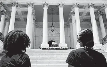  ?? JACQUELYN MARTIN/AP ?? In remembranc­e: Mourners view the flag-draped coffin of Rep. John Lewis on the East Front Steps of the Capitol in Washington during a public viewing Tuesday. The long-serving Georgia congressma­n died July 17 at the age of 80.