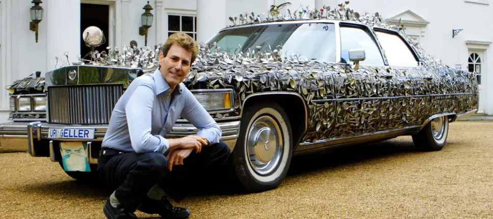  ??  ?? CUTLERY KING: Uri Geller with his Cadillac, covered in bent spoons once owned by every famous person he has met. ‘I touched the Churchill spoon, looked into her eyes and told her she would be prime minister,’ he says of his meeting with Theresa May