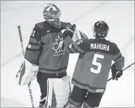  ?? Canadian Press photo ?? Canada's goalie Carter Hart and Josh Mahura celebrate their win over the Czech Republic in World Junior Championsh­ips pre-tournament action in London Ont., on Wednesday.