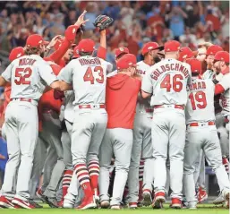  ?? GETTY IMAGES ?? The St. Louis Cardinals celebrate their 13-1 win over the Atlanta Braves in Game 5 of the National League Division Series on Wednesday night. The Cardinals scored 10 runs in the first inning.