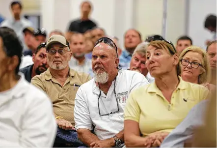  ?? Elizabeth Conley photos / Houston Chronicle ?? Recreation­al fishermen gather at a Texas Parks and Wildlife Department discussion regarding the red snapper season.