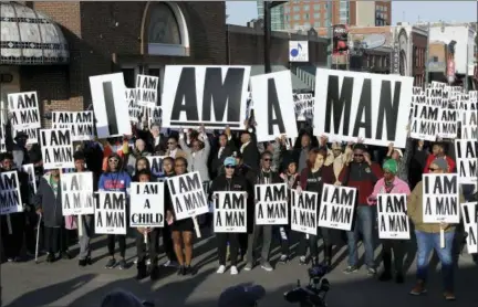  ?? MARK HUMPHREY — THE ASSOCIATED PRESS ?? People hold signs resembling the signs carried by striking sanitation workers in 1968as they join in events commemorat­ing the 50th anniversar­y of the assassinat­ion of the Rev. Martin Luther King Jr. on Wednesday in Memphis, Tenn.