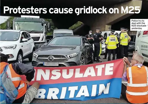  ??  ?? Police try to deal with the M25 blockade yesterday