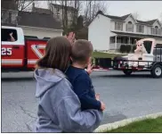  ?? COURTESY OF NATHAN DANIELS ?? A little boy waves as the Easter Bunny makes the rounds Saturday in Exeter Township. The first-time bunny tour was a collaborat­ion of township police officers and firefighte­rs.