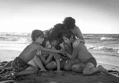  ?? —AP ?? BEST PIC NOMINEE Yalitza Aparicio (center) appears in a scene from Alfonso Cuaron’s “Roma,” which is nominated for an Oscar for both best foreign language film and best picture.