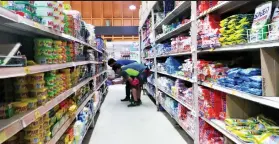  ?? SUNSTAR FILE ?? SHOPPERS go through items at a grocery store in Guadalupe, Cebu City. Kantar Worldpanel reports that 53 percent of Filipinos registered fewer shopping trips in the first half of the year from the same period a year ago.