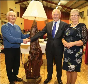  ??  ?? Tom Murphy making a presentati­on on behalf of the community to Henry and Ann Keogh at a party in their honour in Rockchapel Community Centre.