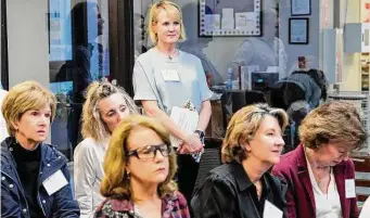  ?? ?? Kathy Bennett, chair of One Hundred Shares Houston, listens to a presentati­on by one of the finalists for the organizati­on’s $100,000 grant.