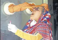  ?? ANI ?? A health worker collects swab sample from a woman at a primary health centre in Gurugram on Monday.