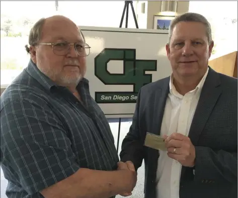  ?? COURTESY PHOTO ?? Brawley native Dale Ramey (left) recieves a “lifetime pass” from CIF-SDS commission­er Jerry Schiepp as recognitio­n for his years of service as a wrestling official.