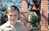  ??  ?? IN HIS FOREFATHER’S FOOTSTEPS: Bryce Tayler, who represents the third generation of his family at Darnall Primary is seen with the school’s centenary bell.