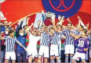  ?? AFP ?? Real Sociedad’s players celebrate with the trophy after winning the 2020 Spanish Copa del Rey (King’s Cup) final football match on April 3.