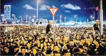  ??  ?? This file photo shows protesters gather near the government headquarte­rs building in Hong Kong to demonstrat­e against plans to introduce Chinese patriotism classes.
