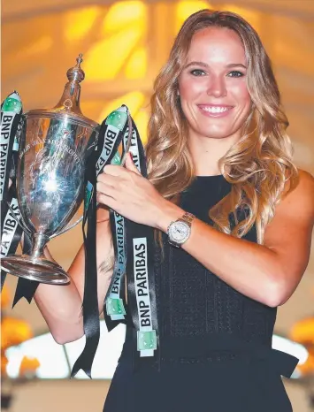  ?? Picture: CLIVE BRUNSKILL/GETTY IMAGES ?? TRIUMPH: Champion Caroline Wozniacki poses with the Billie Jean King trophy after her victory against Venus Williams in Singapore.