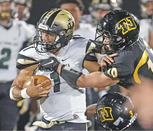  ?? Peter Diana/ Post- Gazette ?? Belle Vernons' Devin Whitlock is wrapped up by Thomas Jefferson defender Ian Hansen Friday at Thomas Jefferson Stadium in Jefferson Hills.