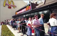  ?? FILE — THE ASSOCIATED PRESS ?? Russians wait in line outside a McDonald’s fast food restaurant in 1991in Moscow.