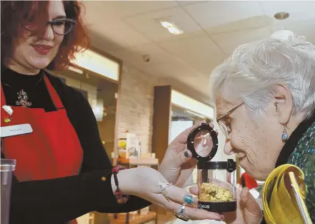  ??  ?? THE GOOD STUFF: State Sen. Patricia Jehlen, above right, smells cannabis displayed by Patient Advocate SarahJaana Nodell during a tour of Revolution­ary Clinics in Somerville yesterday. The shop is located on Broadway and employs more than 40 people,...