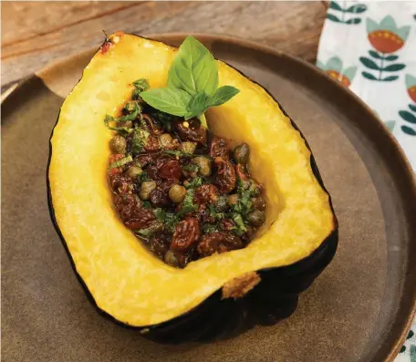  ?? Tns pHOtOs ?? COOK’S CHOICE: Roasted acorn squash can be served with either a sweet and spicy caper-raisin relish or with a mix of butter and sriracha.