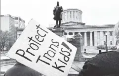  ?? ?? Damage undone: Protesters outside the Ohio statehouse Wednesday, where lawmakers overrode the governor’s veto of a transgende­r bill.