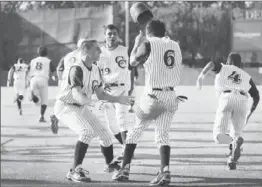  ?? Allen J. Schaben Los Angeles Times ?? CHATSWORTH’S JUSTIN VEGA (6) is greeted by teammates after scoring the winning run. Chatsworth will play El Camino Real for the City Section title.