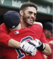  ?? MICHAEL DWYER - THE ASSOCIATED PRESS ?? Boston Red Sox’s J.D. Martinez, rear, celebrates his threerun home run with Brock Holt (12) during the fourth inning of the first game of a baseball doublehead­er against the Baltimore Orioles in Boston, Wednesday, Sept. 26, 2018.