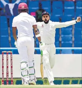  ?? AP PHOTO ?? Virat Kohli exults after the dismissal of Darren Bravo, who was caught behind just before lunch.