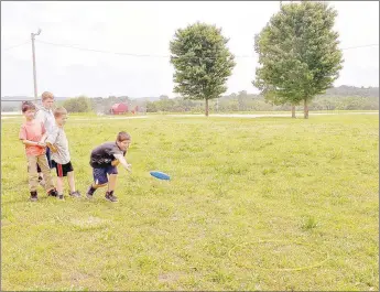  ?? RACHEL DICKERSON/MCDONALD COUNTY PRESS ?? Students in Beverly Jackson’s class at White Rock School take turns trying to toss a flying disc into a ring. Summer school allows kids to be active.