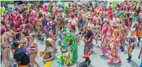  ??  ?? Participan­ts in the Grand Kadooment take to the streets.