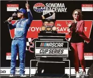  ?? NASCAR Mart ?? Sonoma Raceway Executive Vice President and General Manager Jill Gregory applauds as Kyle Larson takes a drink of wine after winning the 2021 Toyota/Save 350.