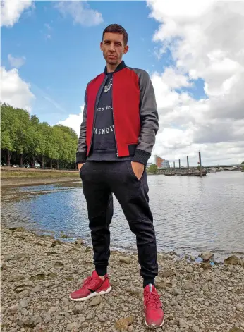  ??  ?? Example, pictured here beside the Thames in London, says fatherhood has changed his music