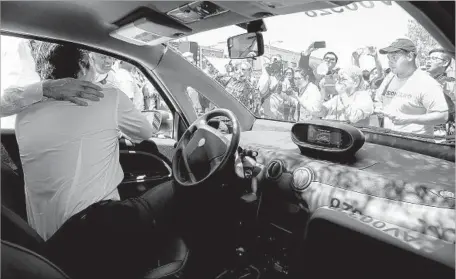  ?? Photograph­s by Mark Boster Los Angeles Times ?? STATE Senate President Pro Tem Kevin de León gets behind the wheel Friday at BlueLA Electric Car Sharing Program news conference.