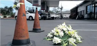  ?? ?? Flowers were left at the petrol station in Tara Road, Bluff where a woman was killed. File Picture: ZAINUL DAWOOD