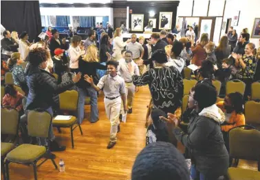  ?? STAFF PHOTO BY TIM BARBER ?? Students from Chattanoog­a Preparator­y School are presented to a rousing round of applause Monday as they pay tribute to Martin Luther King Jr. inside the Bessie Smith Cultural Center.