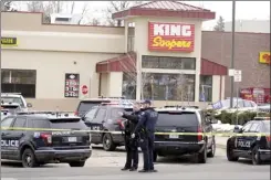  ?? AP photo ?? Police work on the scene outside of a King Soopers grocery store where a shooting took place Monday in Boulder, Colo.