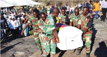 ?? ?? Pall-bearers carry the late liberation hero, Mr Enock Msabaeka’s body to its final resting place at his farm near Old Mutare Mission
