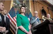  ?? MANUEL BALCE CENETA/AP ?? Sen. Chuck Schumer, gesturing, with congressio­nal colleagues including Nancy Pelosi, says it would be better to spend $50 billion on rebuilding infrastruc­ture.
