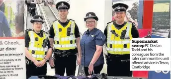  ??  ?? Supermarke­t sweep PC Declan Todd and his colleagues from the safer communitie­s unit offered advice in Tesco, Coatbridge