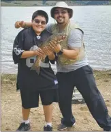  ?? COURTESY NEW MEXICO DEPARTMENT OF GAME & FISH ?? Gilbert Maes and Anthony Maes of Las Vegas caught a 24-inch rainbow trout using chartreuse PowerBait Sept. 3 at Eagle Nest Lake.