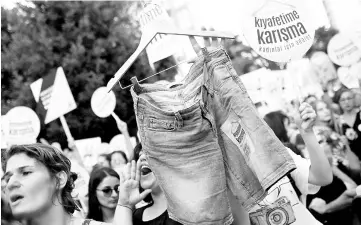  ??  ?? Women rights activists display shorts with a slogan that reads: ‘Don’t Mess With My Outfit’ during a protest against what they say are violence and animosity they face from men demanding they dress more conservati­vely, in Istanbul. — Reuters photo