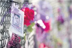  ??  ?? Fans of US musician Prince still leave notes and flowers on a fence outside his home.