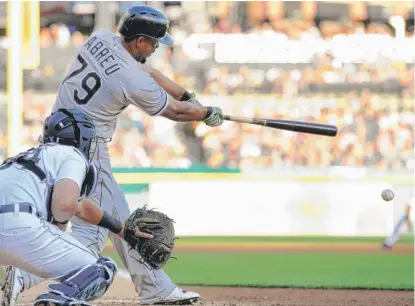  ??  ?? Jose Abreu hits an RBI single in the second inning Saturday off Tigers starting pitcher Myles Jaye. | JOSE JUAREZ/ AP