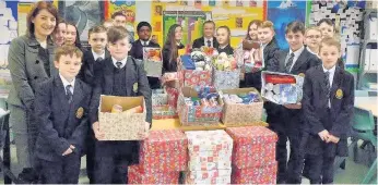  ??  ?? Hamper help Head teacher Miss Connelly with charitable pupils