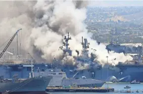  ?? DENIS POROY/AP, FILE ?? Smoke rises from the USS Bonhomme Richard at Naval Base San Diego on July 12, 2020, amid a fire on board the ship.