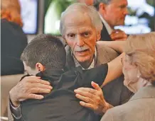  ?? THE ASSOCIATED PRESS ?? Former engine builder and team owner Robert Yates is congratula­ted by family after being announced as a member of the next class that will be inducted into the NASCAR Hall of Fame.