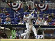  ?? LYNNE SLADKY — ASSOCIATED PRESS ?? Travis d’Arnaud hits his game-winning homer in the 16th inning of the team’s 9-8 win over the Marlins in Miami on Friday.