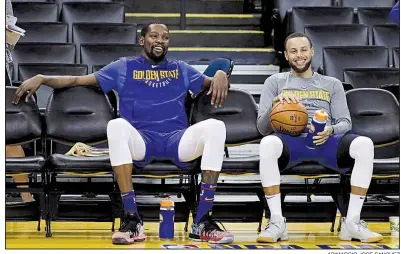  ?? AP/MARCIO JOSE SANCHEZ ?? Kevin Durant (left) and Stephen Curry of the Golden State Warriors take a break during practice Wednesday in preparatio­n for the NBA Finals against the Cleveland Cavaliers. Game 1 is tonight in Oakland, Calif.